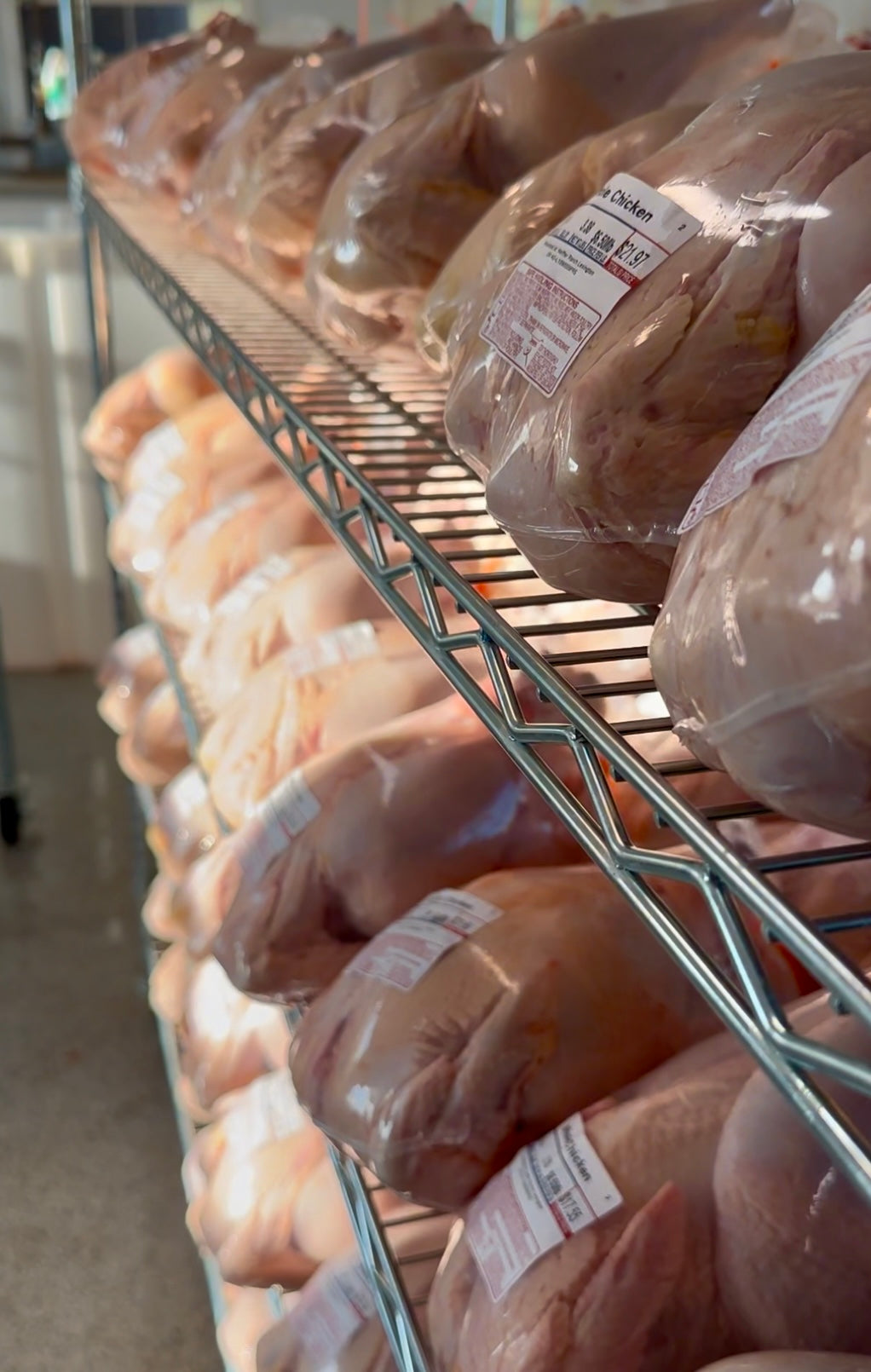 Shelving unit with packaged chickens in a warehouse setting